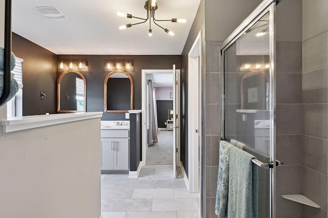 515 Goldenrod Trl, Waconia, MN 55387 - full bathroom featuring vanity, a chandelier, a shower stall, tile patterned floors, and baseboards
