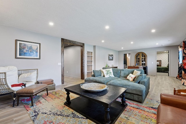 515 Goldenrod Trl, Waconia, MN 55387 - living area with light wood-type flooring, a textured ceiling, recessed lighting, baseboards, and built in features