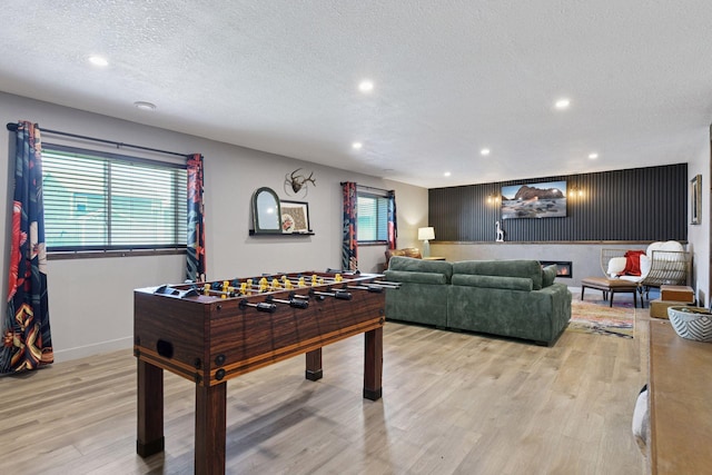 515 Goldenrod Trl, Waconia, MN 55387 - game room with light wood finished floors, a textured ceiling, recessed lighting, and baseboards