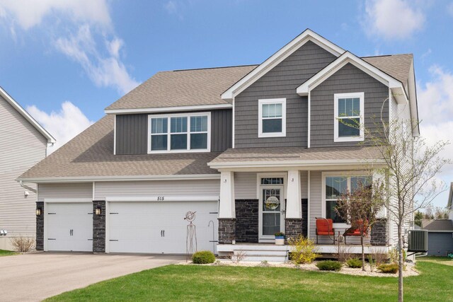 515 Goldenrod Trl, Waconia, MN 55387 - craftsman-style home featuring a porch, concrete driveway, a front lawn, and a shingled roof