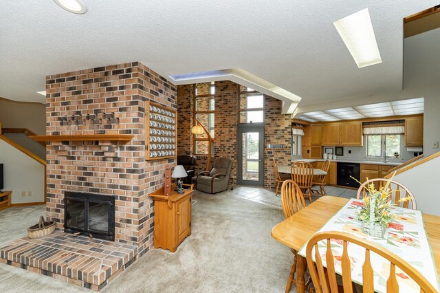 8706 Town Hall Rd NW, Byron, MN 55920 - dining area with a brick fireplace, light carpet, and a textured ceiling
