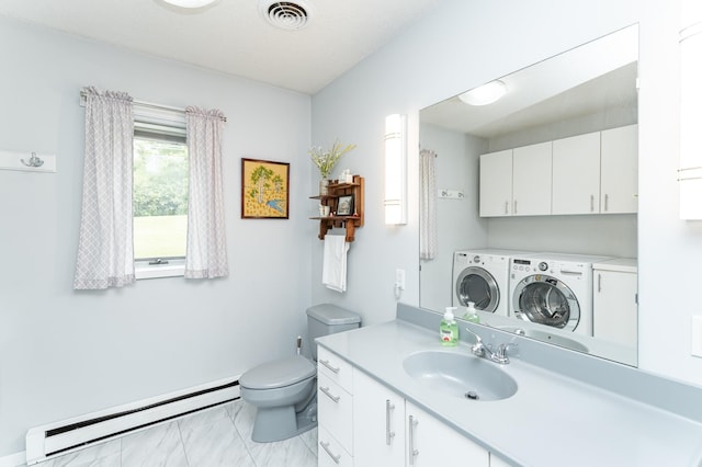8706 Town Hall Rd NW, Byron, MN 55920 - full bath featuring separate washer and dryer, baseboard heating, vanity, and toilet