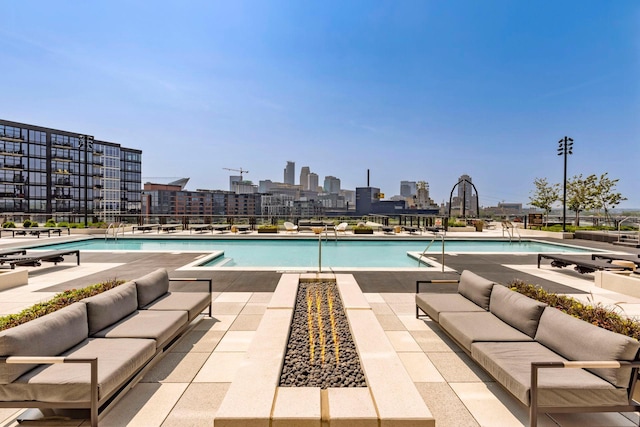 1111 River Pkwy Unit 26C, Minneapolis, MN 55415 - community pool featuring an outdoor living space, a patio, and a skyline view
