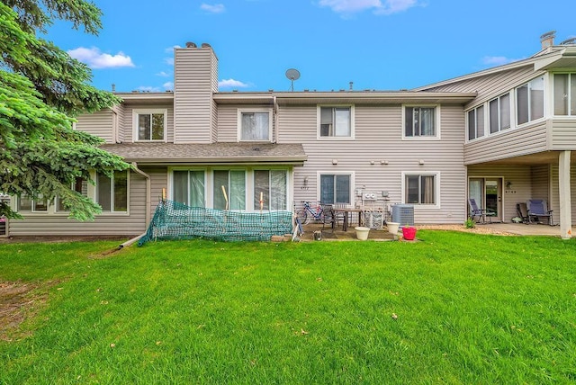 8712 Cottonwood Ln, Maple Grove, MN 55369 - back of house with a patio area, a yard, a chimney, a sunroom, and central AC