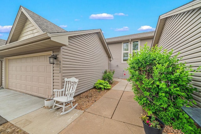 8712 Cottonwood Ln, Maple Grove, MN 55369 - view of side of home with an attached garage, driveway, and roof with shingles