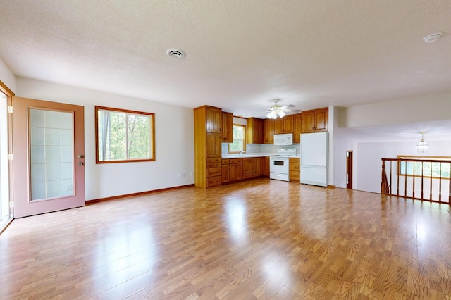 21341 County 50, Park Rapids, MN 56470 - unfurnished living room with ceiling fan, light wood-type flooring, a sink, baseboards, and a textured ceiling