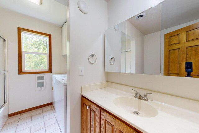 21341 County 50, Park Rapids, MN 56470 - bathroom with washer and dryer, heating unit, vanity, a shower with door, and baseboards