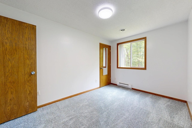 21341 County 50, Park Rapids, MN 56470 - carpeted spare room featuring a baseboard heating unit, baseboards, and a textured ceiling