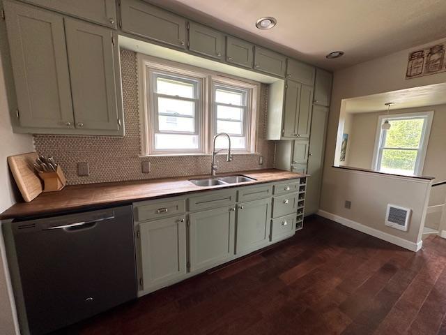 7 Shagawa Rd, Ely, MN 55731 - kitchen with dishwasher, a sink, baseboards, dark wood-style flooring, and tasteful backsplash