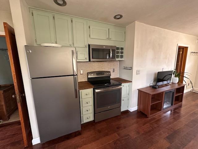 7 Shagawa Rd, Ely, MN 55731 - kitchen with appliances with stainless steel finishes, dark wood-style floors, decorative backsplash, and baseboards