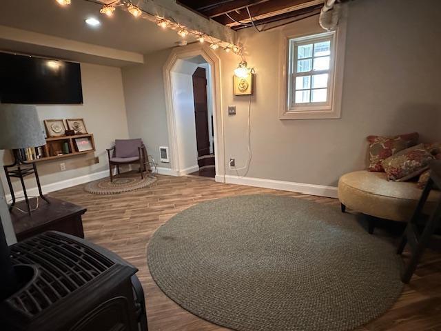 7 Shagawa Rd, Ely, MN 55731 - sitting room featuring baseboards, wood finished floors, and arched walkways