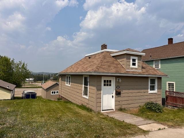 7 Shagawa Rd, Ely, MN 55731 - back of property featuring a chimney and roof with shingles