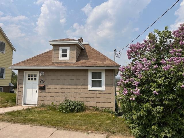 7 Shagawa Rd, Ely, MN 55731 - view of front of home featuring a chimney and roof with shingles