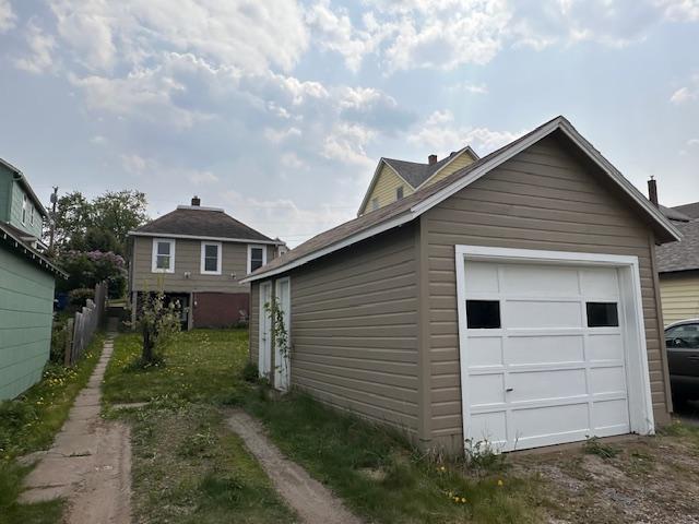 7 Shagawa Rd, Ely, MN 55731 - view of home's exterior featuring a garage and dirt driveway