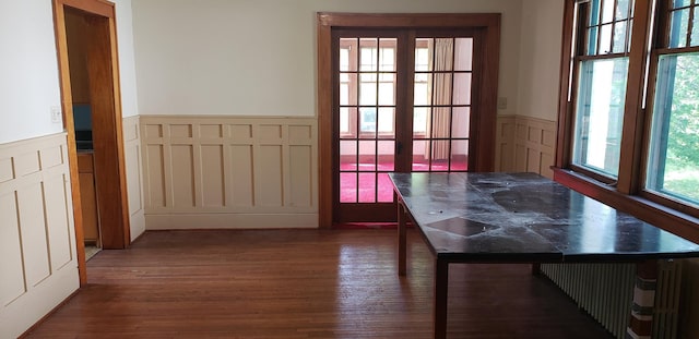 420 Spring St, River Falls, WI 54022 - entryway featuring wainscoting, wood finished floors, and a decorative wall