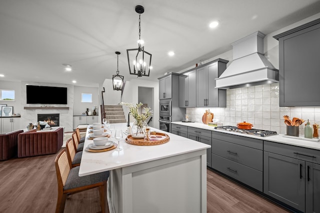 14810 106th Ave N, Maple Grove, MN 55369 - kitchen with gray cabinetry, custom range hood, stainless steel appliances, light countertops, and recessed lighting