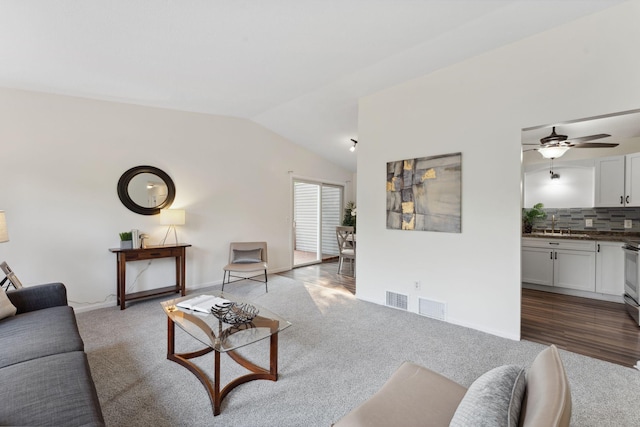583 97th Ln NE, Blaine, MN 55434 - living room with carpet, vaulted ceiling, a ceiling fan, and baseboards
