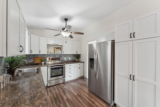 583 97th Ln NE, Blaine, MN 55434 - kitchen featuring appliances with stainless steel finishes, decorative backsplash, dark countertops, white cabinetry, and ceiling fan