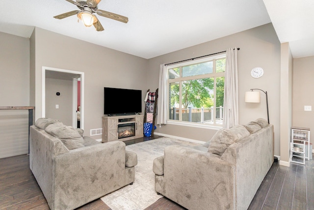 414 Bremen Pass, Waverly, MN 55390 - living room with dark wood finished floors, a ceiling fan, baseboards, and a glass covered fireplace