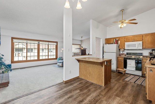 1977 Granite Ave N, Oakdale, MN 55128 - kitchen with white appliances, dark wood-style flooring, a peninsula, brown cabinetry, and open floor plan