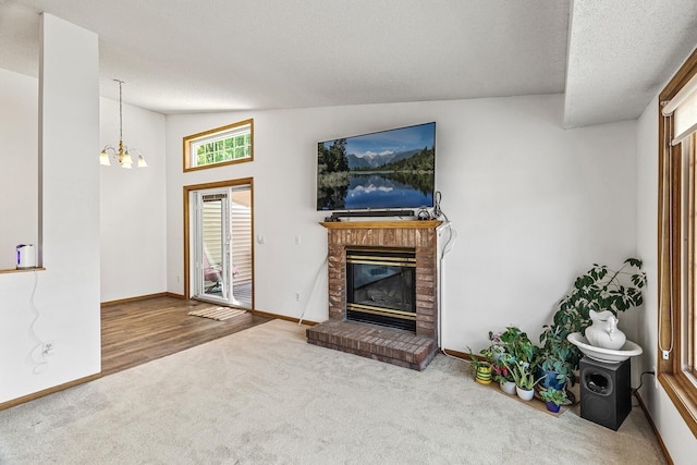 1977 Granite Ave N, Oakdale, MN 55128 - unfurnished living room with carpet, a chandelier, a brick fireplace, baseboards, and a textured ceiling