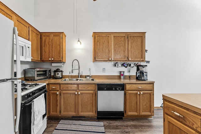 1977 Granite Ave N, Oakdale, MN 55128 - kitchen featuring white appliances, a sink, a high ceiling, dark wood-style floors, and brown cabinets