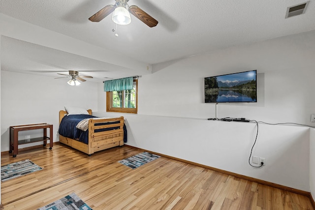 1977 Granite Ave N, Oakdale, MN 55128 - bedroom with light wood-style flooring, baseboards, a ceiling fan, and a textured ceiling