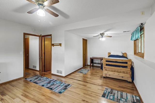 1977 Granite Ave N, Oakdale, MN 55128 - bedroom featuring wood finished floors, baseboards, ceiling fan, and a textured ceiling