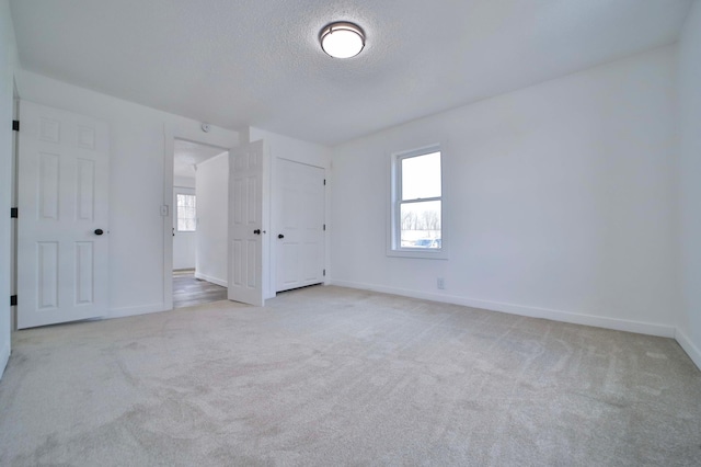 32736 203rd Ave, Clarissa, MN 56440 - unfurnished bedroom featuring light colored carpet and a textured ceiling