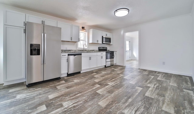 32736 203rd Ave, Clarissa, MN 56440 - kitchen with appliances with stainless steel finishes, dark wood-style floors, white cabinetry, light stone counters, and a textured ceiling