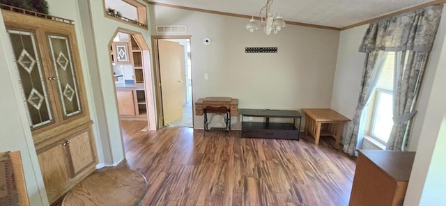 68005 County Road 3, Bandon Twp, MN 55332 - unfurnished dining area featuring crown molding, dark wood-type flooring, and a chandelier