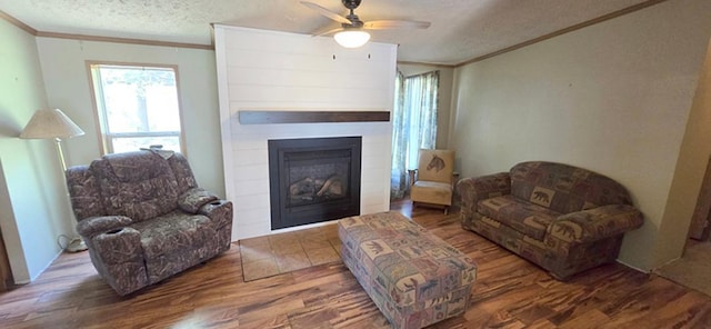 68005 County Road 3, Bandon Twp, MN 55332 - living room featuring ornamental molding, a textured ceiling, a fireplace, wood finished floors, and a ceiling fan