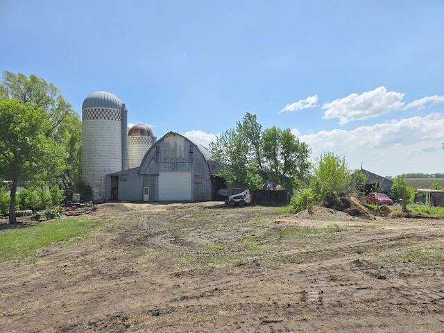 68005 County Road 3, Bandon Twp, MN 55332 - view of yard featuring a garage, an outbuilding, a barn, and driveway