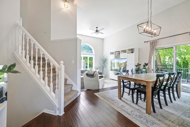 4417 Braddock Trl, Eagan, MN 55123 - dining room featuring stairway, wood-type flooring, a ceiling fan, baseboards, and a high ceiling