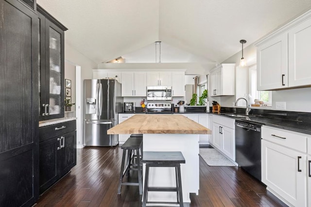 4417 Braddock Trl, Eagan, MN 55123 - kitchen with appliances with stainless steel finishes, a sink, butcher block counters, lofted ceiling, and dark wood-type flooring