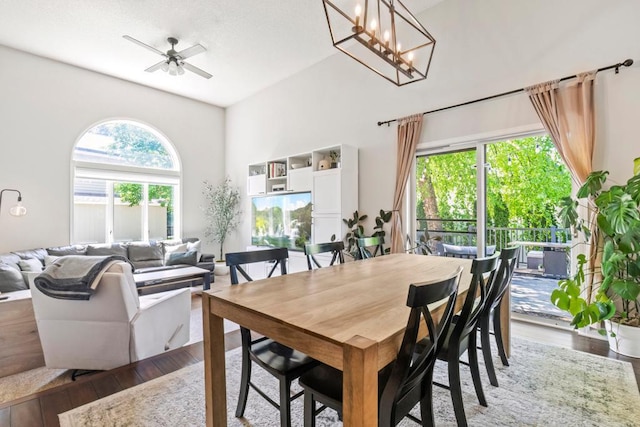 4417 Braddock Trl, Eagan, MN 55123 - dining room featuring wood finished floors, plenty of natural light, a ceiling fan, and a towering ceiling