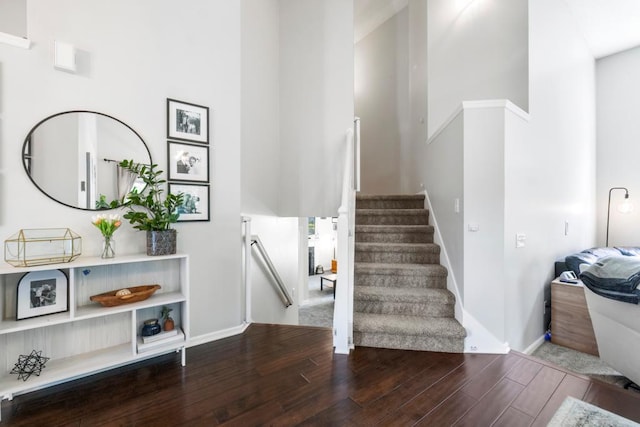 4417 Braddock Trl, Eagan, MN 55123 - staircase featuring a towering ceiling, wood finished floors, and baseboards