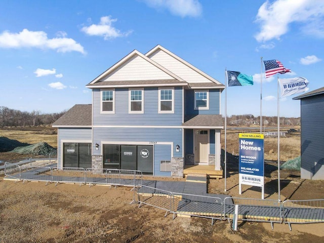 23548 Ashbury Dr, Rogers, MN 55374 - view of front of home featuring stone siding and a shingled roof