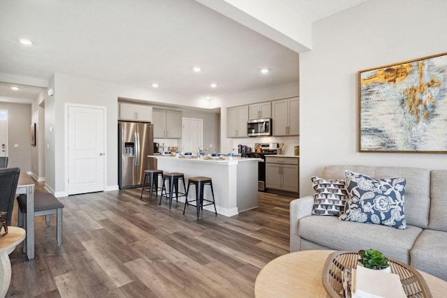 23548 Ashbury Dr, Rogers, MN 55374 - living area with dark wood-style flooring, recessed lighting, and baseboards