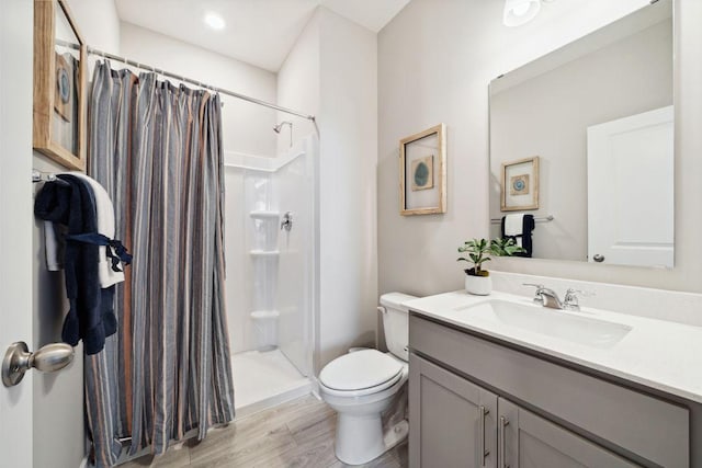 23548 Ashbury Dr, Rogers, MN 55374 - bathroom with toilet, vanity, a shower with curtain, and wood finished floors