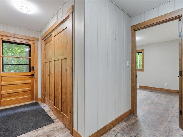 15622 Sand Beach Park, Bay Lake Twp, MN 56444 - entryway featuring baseboards, wood finished floors, and wood walls