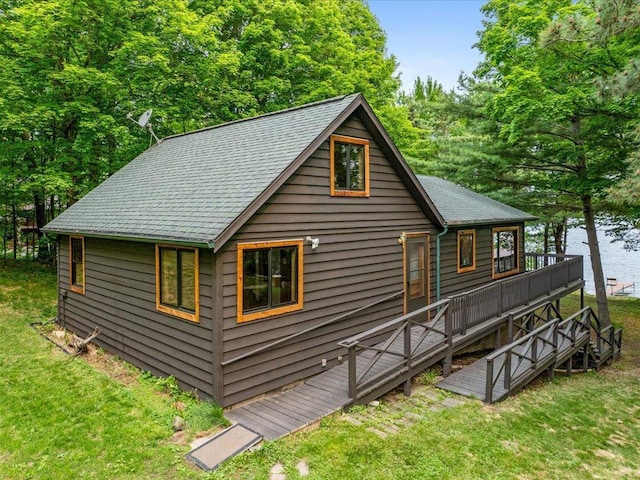 15622 Sand Beach Park, Bay Lake Twp, MN 56444 - view of front facade with a front lawn, a deck with water view, and a shingled roof