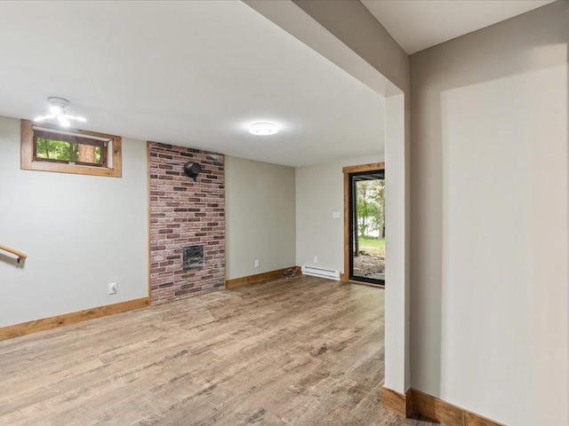 15622 Sand Beach Park, Bay Lake Twp, MN 56444 - unfurnished living room with a baseboard radiator, wood finished floors, baseboards, and a fireplace