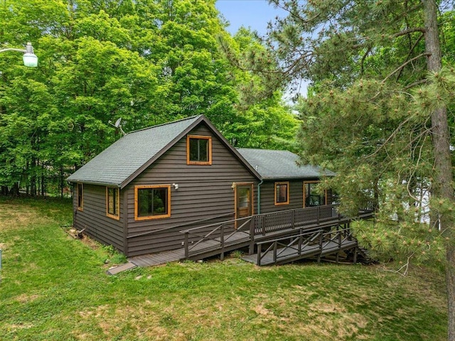 15622 Sand Beach Park, Bay Lake Twp, MN 56444 - rear view of house featuring a lawn, a wooden deck, and a shingled roof