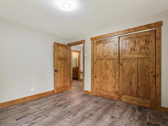 15622 Sand Beach Park, Bay Lake Twp, MN 56444 - unfurnished bedroom featuring wood finished floors, baseboards, and a closet