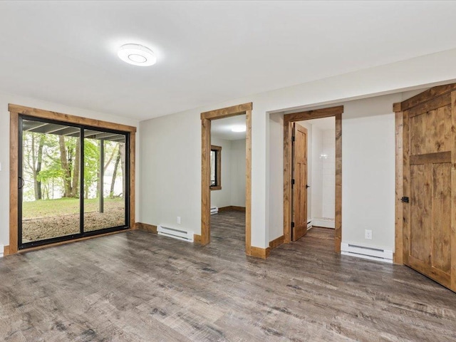 15622 Sand Beach Park, Bay Lake Twp, MN 56444 - empty room featuring a baseboard heating unit, wood finished floors, and baseboards