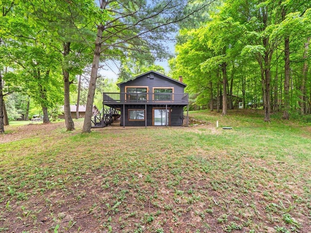 15622 Sand Beach Park, Bay Lake Twp, MN 56444 - back of house featuring stairway, a wooden deck, a chimney, and a lawn