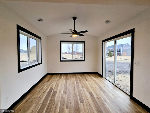 1109 9th Ave SE, Waseca, MN 56093 - empty room featuring lofted ceiling, light wood-type flooring, baseboards, and a ceiling fan