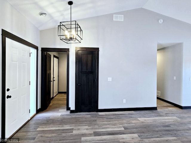 1109 9th Ave SE, Waseca, MN 56093 - foyer with lofted ceiling, a chandelier, wood finished floors, and baseboards