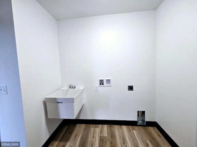 1109 9th Ave SE, Waseca, MN 56093 - washroom featuring wood finished floors, hookup for a washing machine, and hookup for an electric dryer